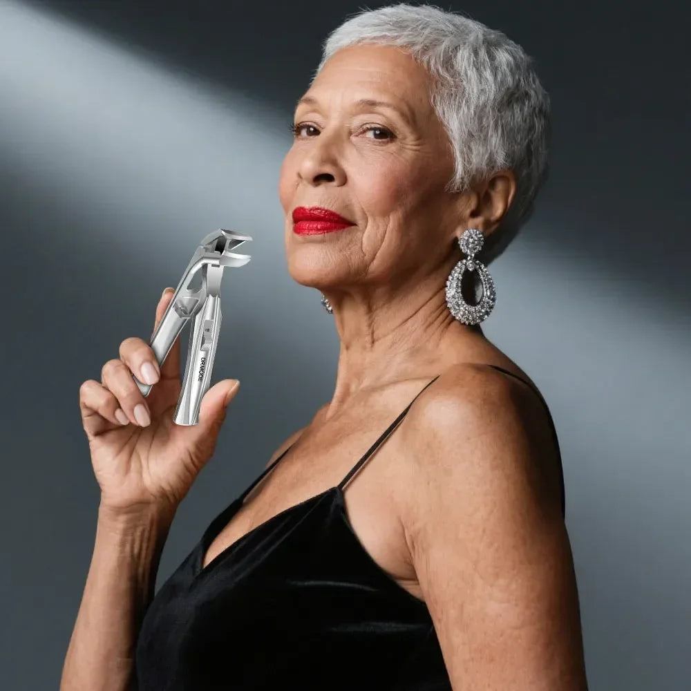 Elegant older woman in black dress holding stainless steel nail clippers, jewelry visible