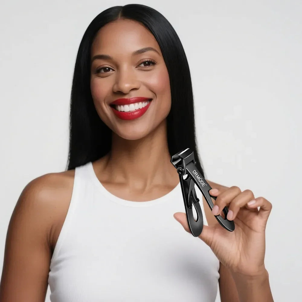 Smiling woman holding black nail clippers in hand, grooming tool against white background
