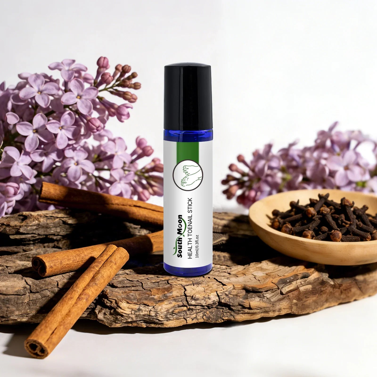 Herbal toenail treatment stick with cinnamon, cloves, and lilac flowers on rustic wood.