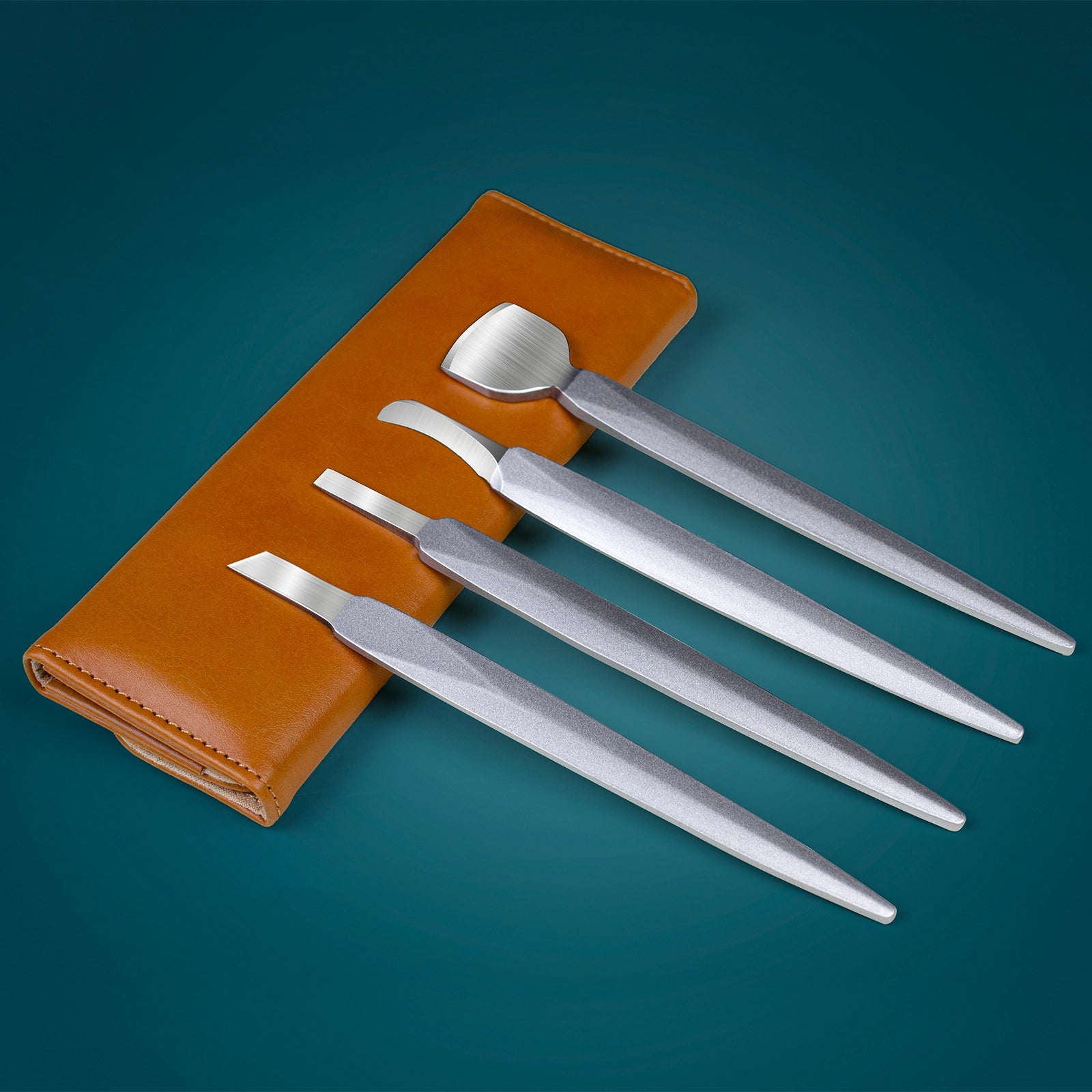Set of stainless steel nail care tools displayed with brown leather case on blue background
