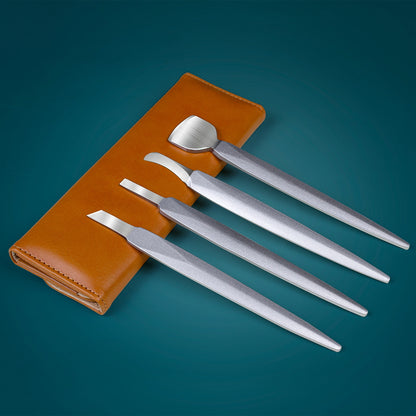 Set of stainless steel nail care tools displayed with brown leather case on blue background