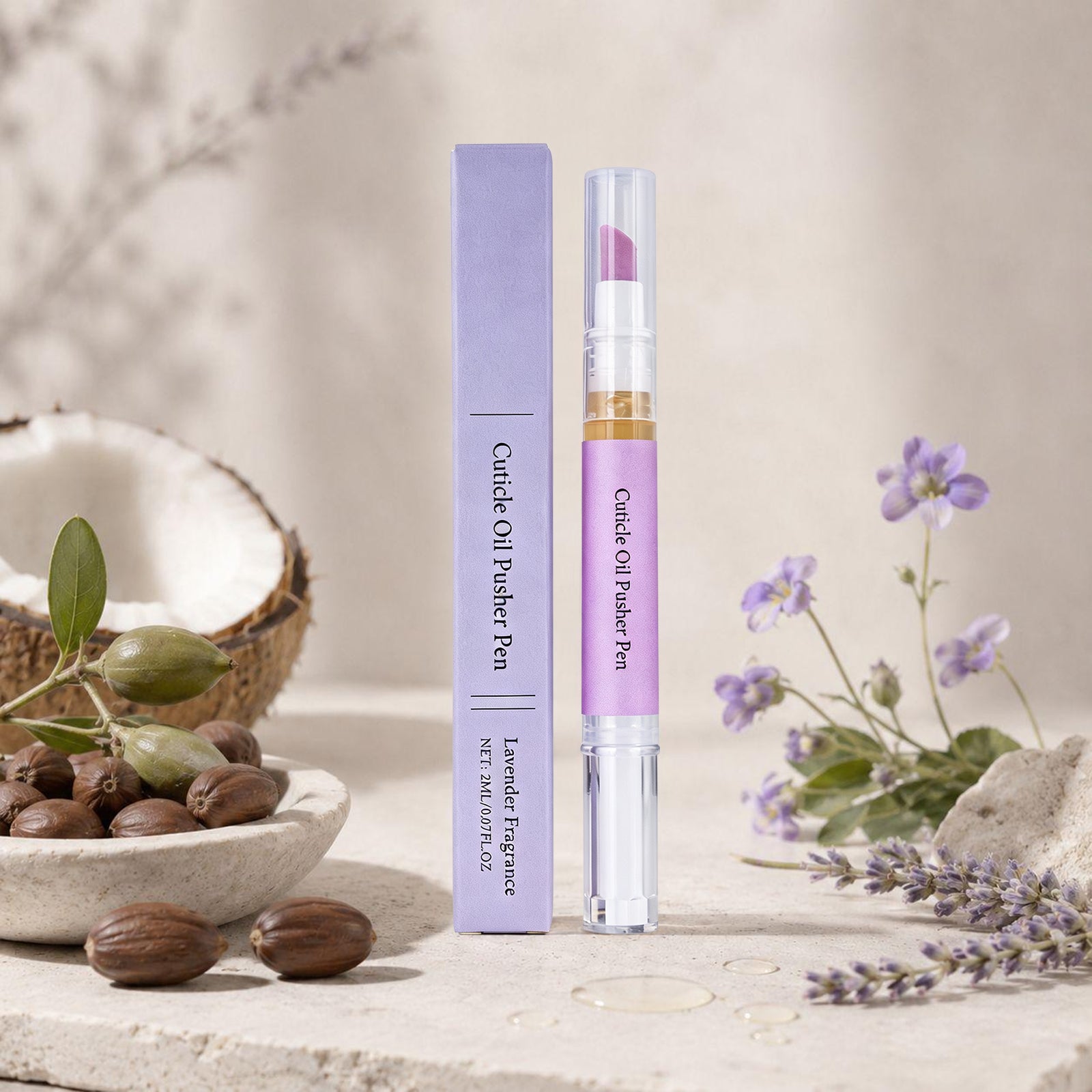 Cuticle oil pen surrounded by natural ingredients including coconut, jojoba beads and fresh lavender flowers