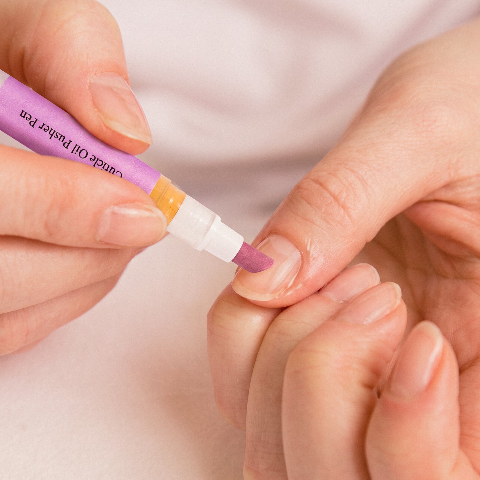 Detailed application of nail care pen onto fingernail cuticle for targeted nourishment delivery